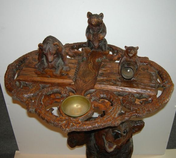 This charming carved smoker is of the highest quality carving with great expression on each bear. The tall standing base bear has a hinged head for storing cigars. The top center bear holds your pipe, while one holds a match barrel. Both the two