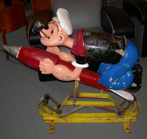 From a childrens carousel in France, the Popeye rocket  figure is one of the most charming ever created. He has great old paint, many layers deep. The wood shows some wear and slight splits, but adds to the overall character of the piece. He can