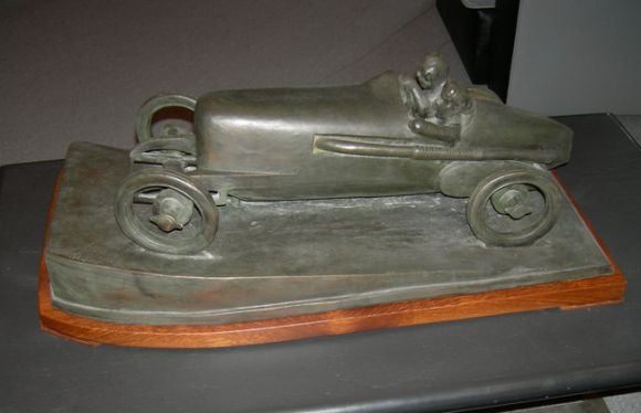 Born in Prague in 1892, Stefan created mostly cubistic figural sculptures. In the 1920's, he did a series of sports related sculptures, including this wonderfully stylized boat tail racer. The driver is veering into the curve, seeming to lean into
