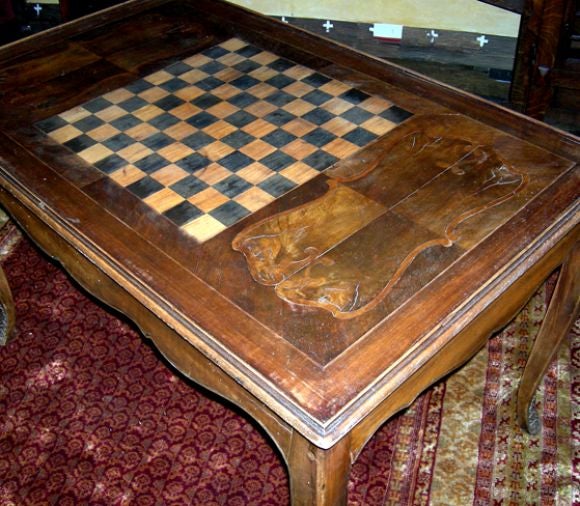 A finely crafted petite leather topped desk becomes a felt topped, cushioned card and dice table. With a flip of the top, the reverse side is a lovely inlaid chess table with elegant inlaid wood side decorative panels.The legs are tipped with dainty
