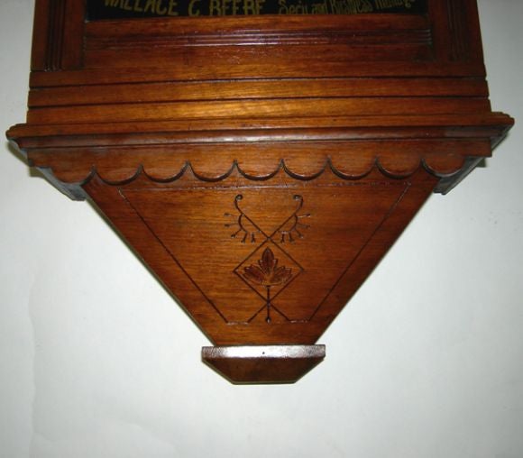 This charming clock says it all- they sold furniture, picture frames, and undertaking! The reverse painted glass is in very nice condition, as is the mahogany finished cabinet. The clock is a wind up (with key) in working condition.