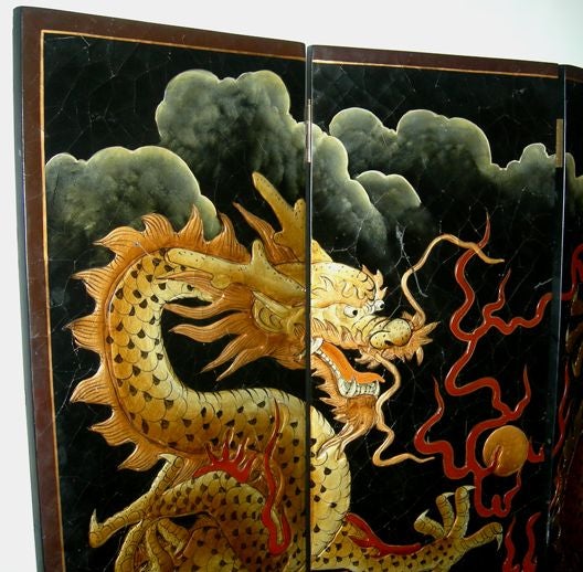 The composition of the two opposing dragons is what attracted us to this marvelous screen. The strong imagery and use of space is quite compelling. The wonderful crazing throughout the lacquer suggests the age, adding an overall patinated feel. The