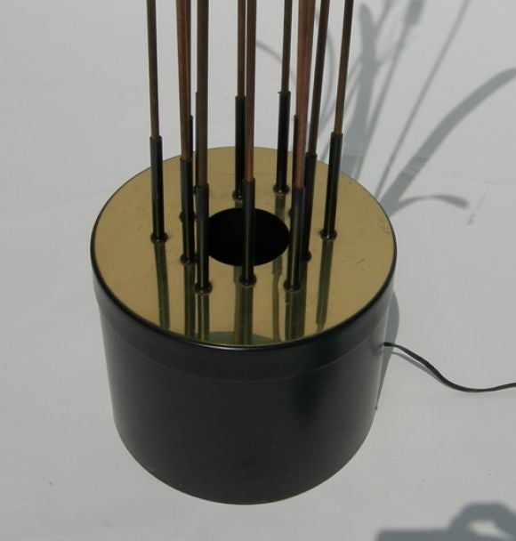 This ingenious light sculpture is quite remniscent of the work of Curtis Jere. The leaves, cat tails, and sprays are a combination of brass and copper. Each element is removable for bulb access and re-arrangments. A single center bulb casts a