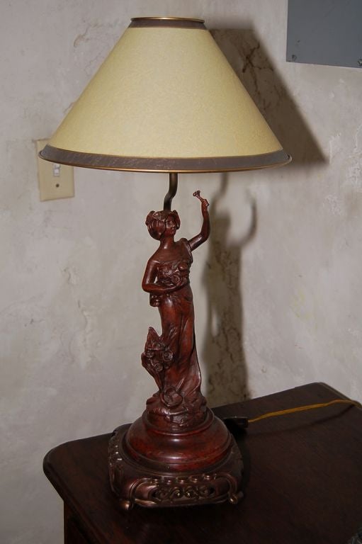 19th century Spelter figurine on antique base made into lamp with shade 22'' H with shade x 7'' W.
