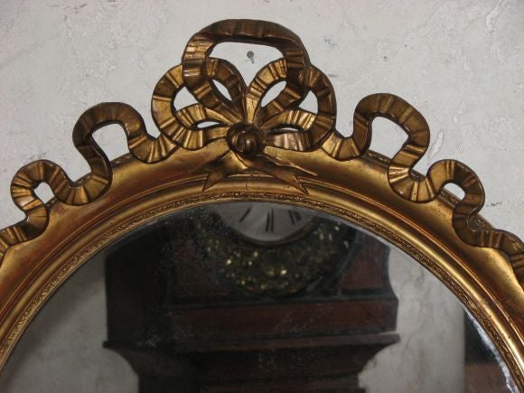 19th century French gold doré mirror with bow,
Measures: 34