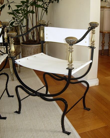 Sharp looking in white leather, black painted iron frames and brass details