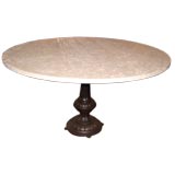Round travertine top dining table w/ cast iron pedestal