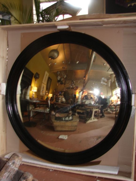 Supersized convex mirror, with beautifully restored antique ebonized frame.