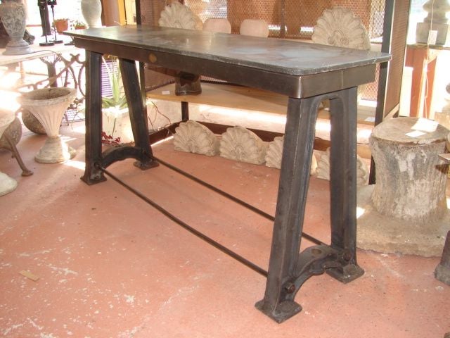 Industrial cast iron work table base from a Belgian shoe factory, with old bluestone top.