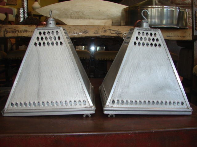 Pair of pierced aluminium light fixtures