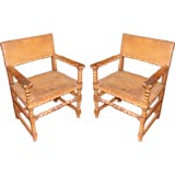 Pair of leather studded armchairs