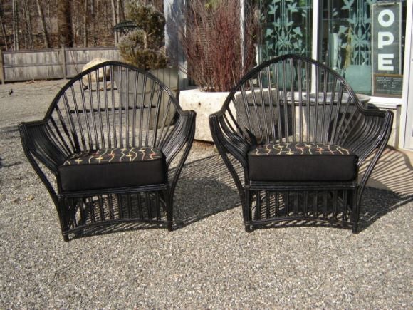 Pair of large and dramatic vintage rattan armchairs in the original black painted finish, by Heywood Wakefield. With seat and back cushions.