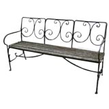 Wrought iron bench with slatted wood seat