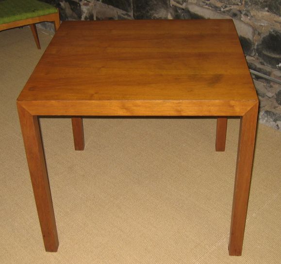 Simple walnut Parsons table by Dunbar.