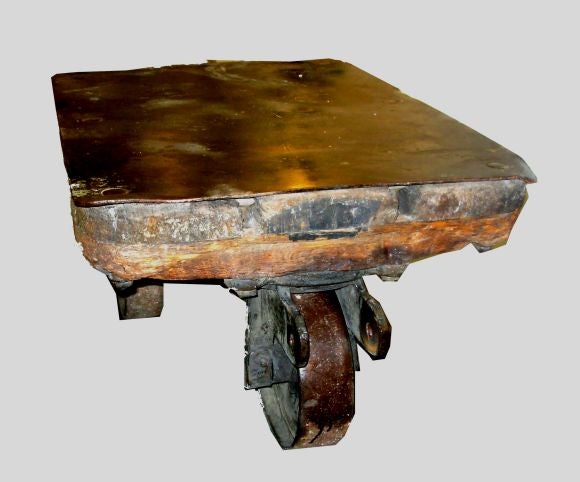 A three wheels, small size industrial cart with metal top and wheels and a thick wooden structure.  Beautiful antique patina.<br />
Perfect as a cocktail table for a loft or a country house
