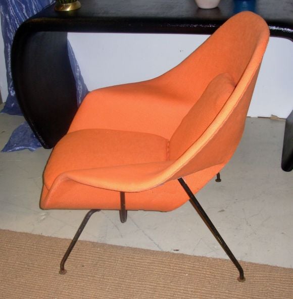 Original 50's womb chair re-upholstered with a light orange cotton fabric.