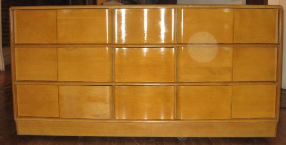 A nine drawers dresser wisH undulate front.  Rectangular mirror also available
