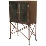 Antique industrial cabinet / vitrine with dolphin shaped feet