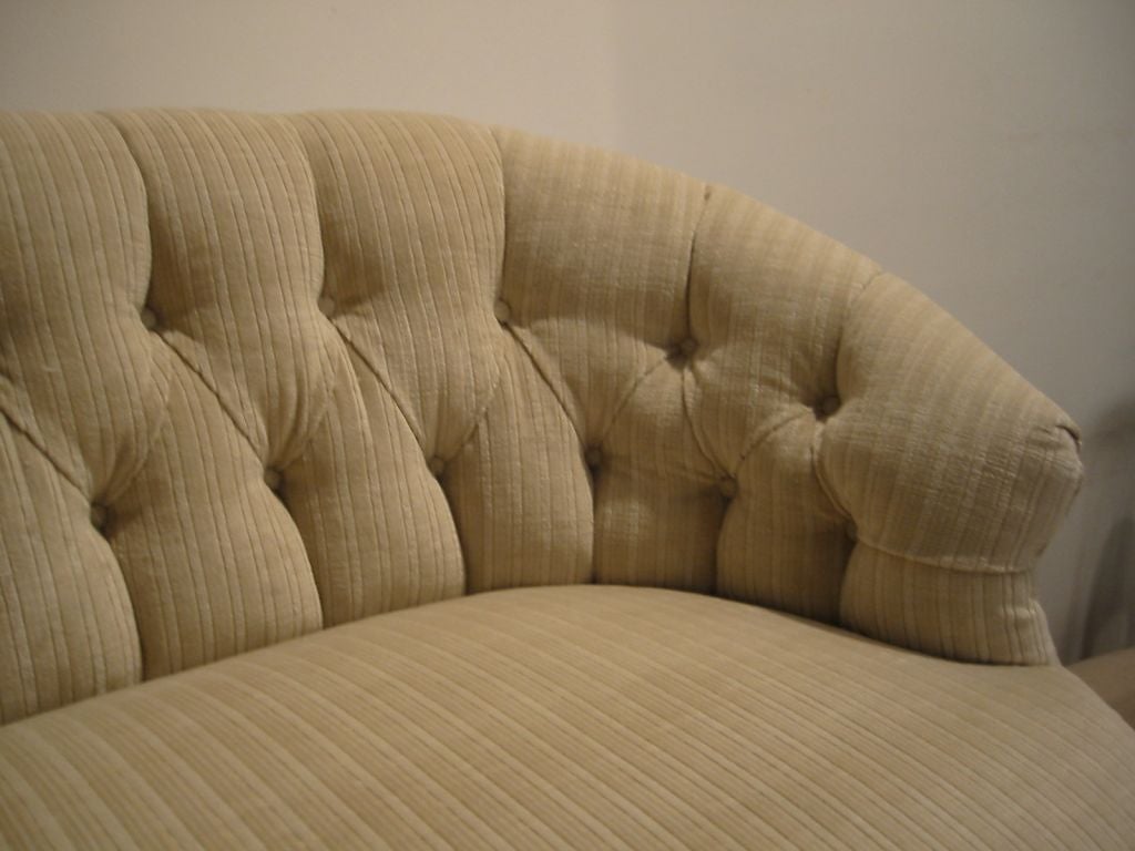 Lovely Antique Mahogany Victorian Loveseat with turned front legs and flaired back legs,newly upholstered with tufted back in creamy      <br />
color velvet.