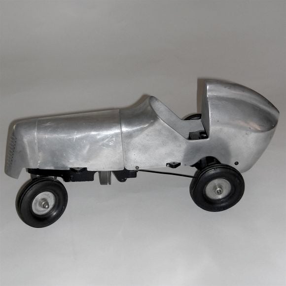 This great original tethered racing car was actually raced on a track back in the 1930's. It is powered by gasoline and has a small gas tank and one spark plug. It has a very heavy cast aluminum body with real rubber tires.