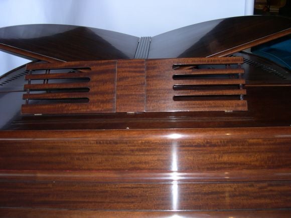 Of all the Wurlitzer Butterfly Pianos we've seen, this model has the best detailing. The design of the music stand mimics the streamline banding. The design of the wood that backs the pedals has great art deco detailing as well. The walnut is
