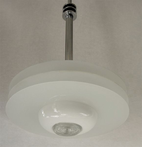 A great streamline chandelier with beautifully designed original details including original stepped caps, a ridged pole that matches the ridges in the hand-blown white glass shades, three rings that match the frosted glass rings that sit on the