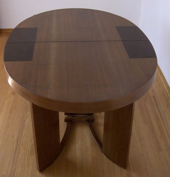 This rare table was designed by Gilbert Rohde for Herman Miller in 1933 and exhibites at the Chicago world's Fair. The warm, rich walnut table top and base are highlighted by contrasting dark walnut burl inlaid rectangle sections on the top. There