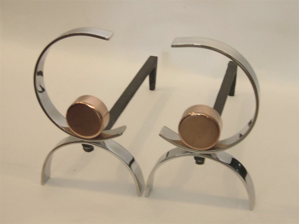 These art deco andirons have a clean streamline design. They are nickel with copper accents. These are very substantial and well constructed pieces from the late 1930's.