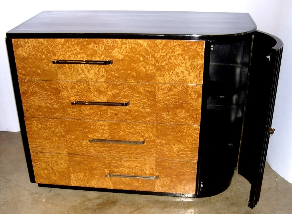 This rare suite of dressers is absolutely beautiful. It is finished in hand polished high gloss lacquer with nickel plated machine age hardware. The asymmetrical height of the tall dresser creates a very unique and interesting design. The low