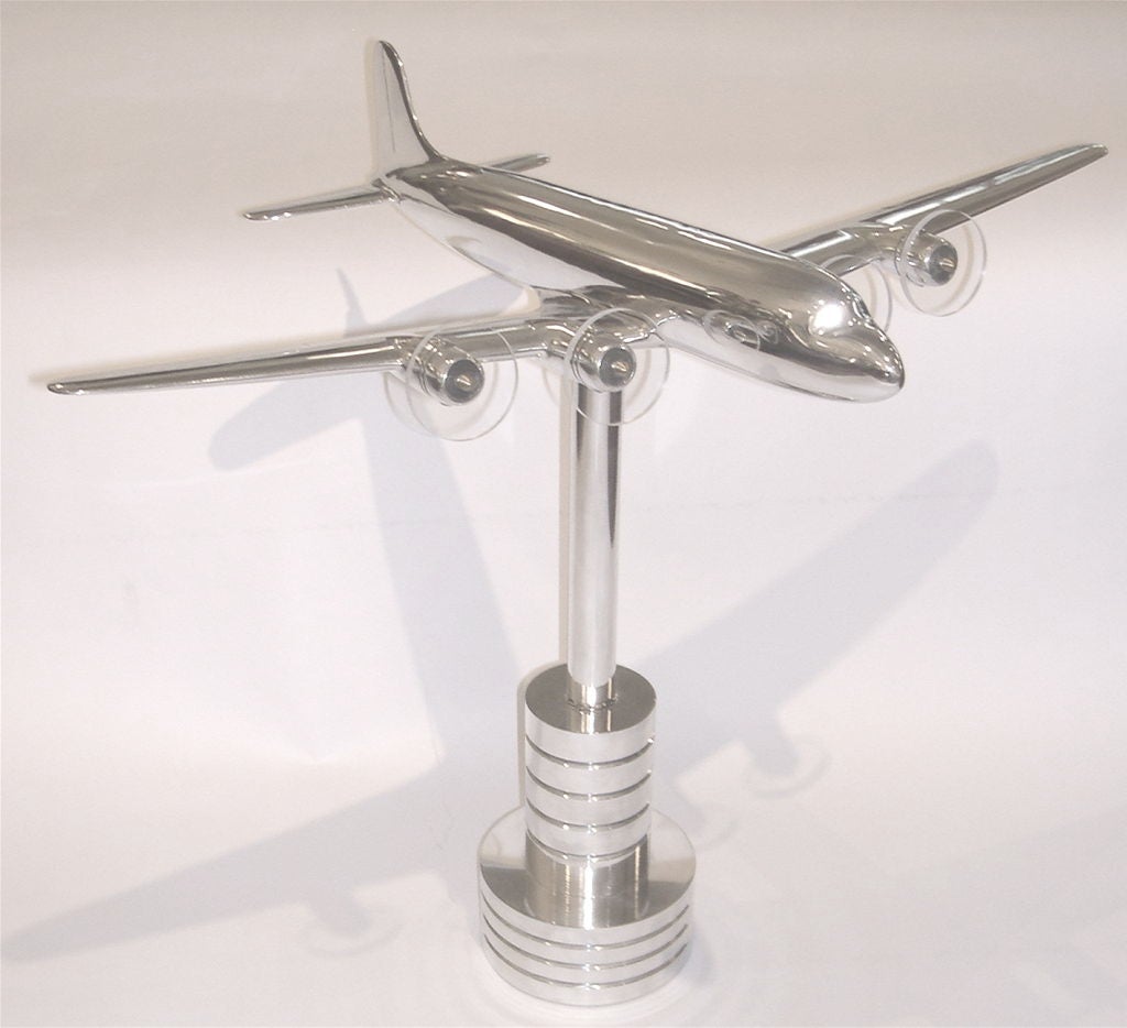 This is a cast aluminum scale model of a DC6 produced by Douglas Aircraft Co. in 1948. This plane is perched on a wonderful hand lathed base. These planes were produced in small quantity and used as promotionals for the newest models. Cast in