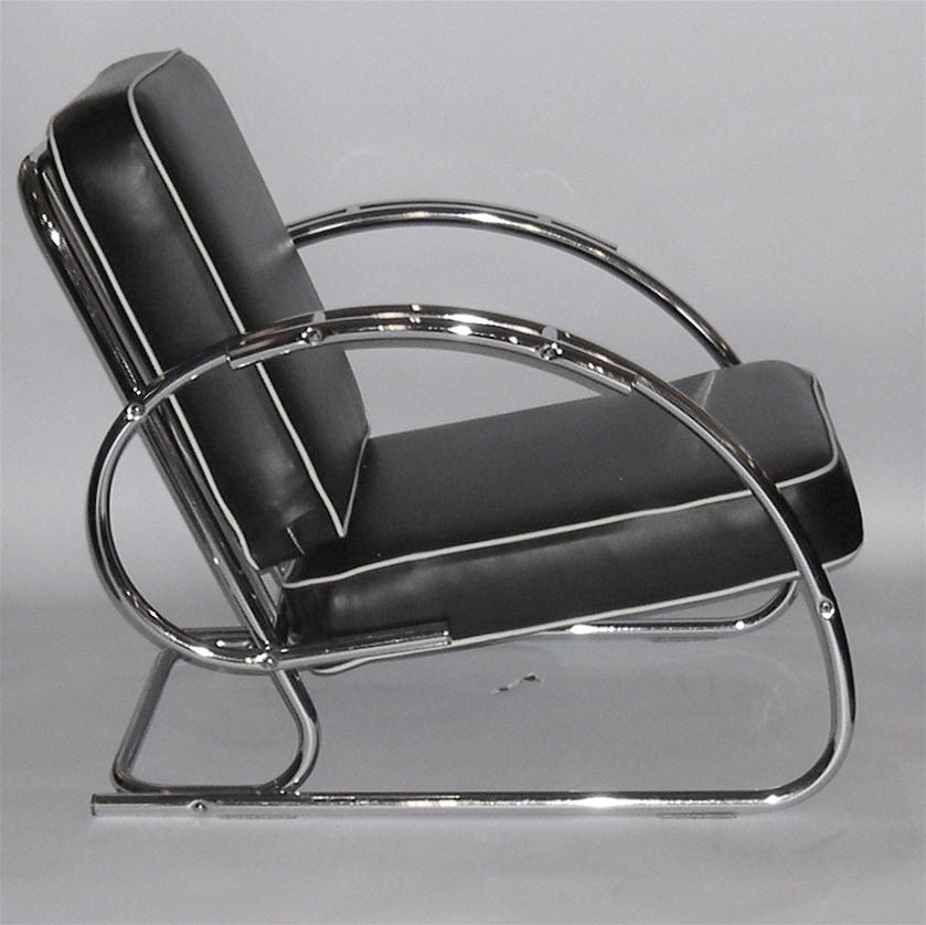 These chairs have been attributed to KEM Weber by several  auction houses. Their low  profile and sleek curving arms make them the epitome of streamline moderne design. The extra curved armrest adds an extra dimension of design as well as comfort.