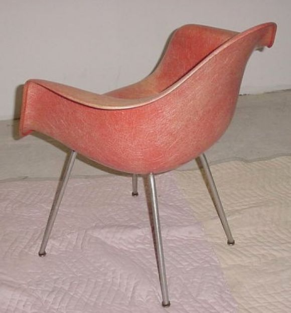 A super-fine example of Charles and Ray Eames' Shell chair manufactured by  Zenith Plastics for Herman Miller, circa 1950.  Beautiful fibers, visible rope edge and rare coral color mounted on X-base. Retains quad label.