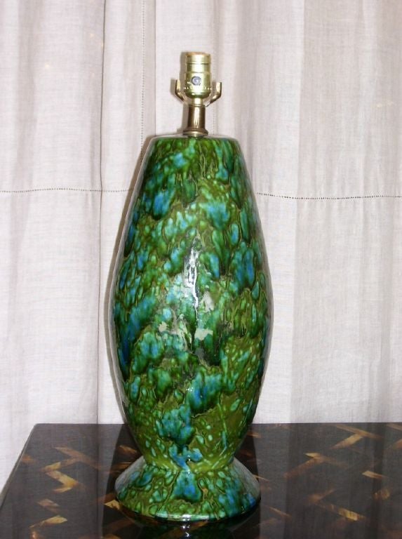 TALL GLAZED CERAMIC TABLE LAMP IN PEACOCK GREEN AND BLUE COLORS.