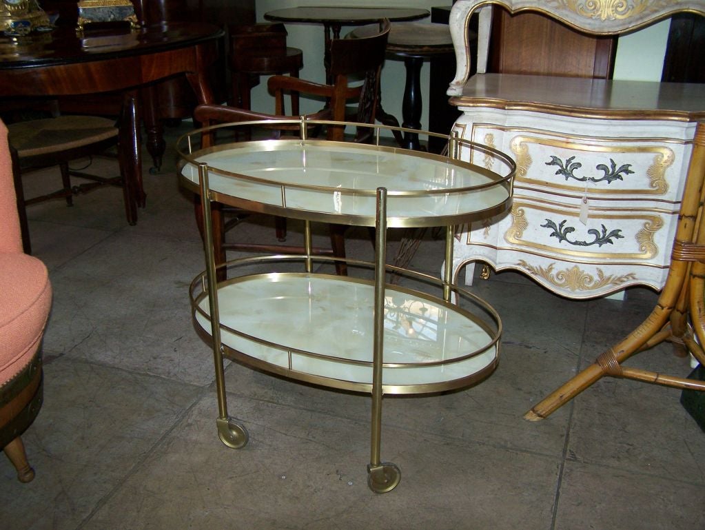 ELEGANT TEA CART WITH TWO TIERS. SHELVES ARE FAUX ALABASTER PAINTED GLASS. SOLID BRASS FRAME.