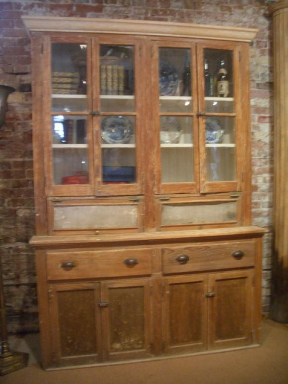 Pine hutch with glass doors and brass hardware.