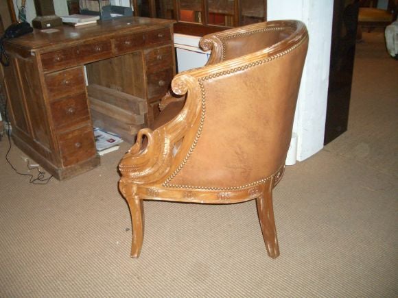 French leather chair with carved swan detail. Oak frame