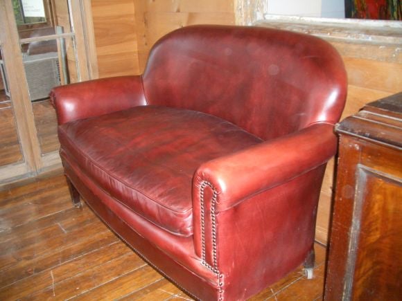 Leather upholstered loveseat with nailhead detail