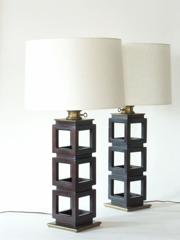 Mahogany cube frame table lamps with patinated brass base and neck.