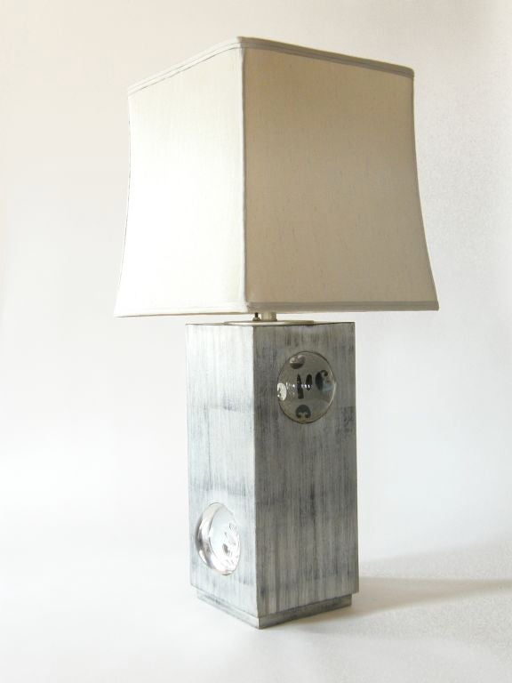 This exceptional table lamp has four inset glass lenses with reverse etched tsuba designs. The lamp lights with a 3-way switch on top, and the base also lights from within. With the internal light on, the lenses glow, and you get fabulous optical
