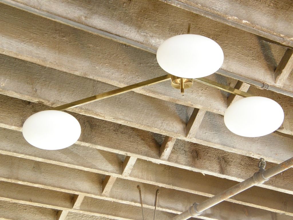 Three arm ceiling fixture with elliptical glass globes