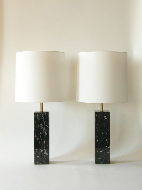 Lovely pair of rich black marble lamps with veining that runs from cream to a smokey grey blue color by Nessen.
