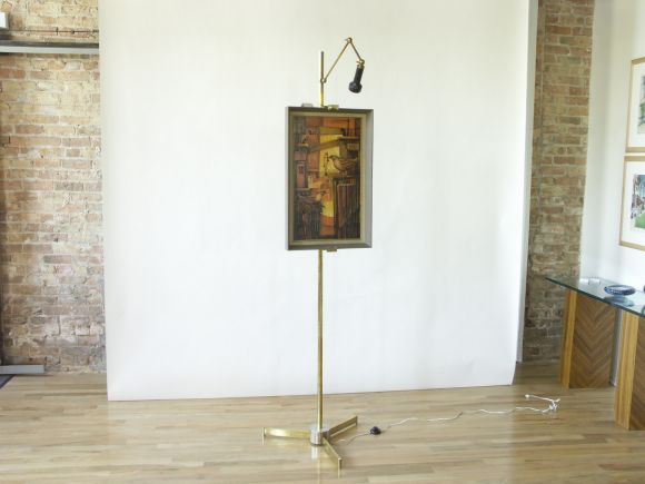 This c. 1950s easel with adjustable light fixture was manufactured by Arredoluce of Monza, Italy.  They made a few slightly different versions of the easel.  This variation in brass has the simpler base with a chrome finished center.