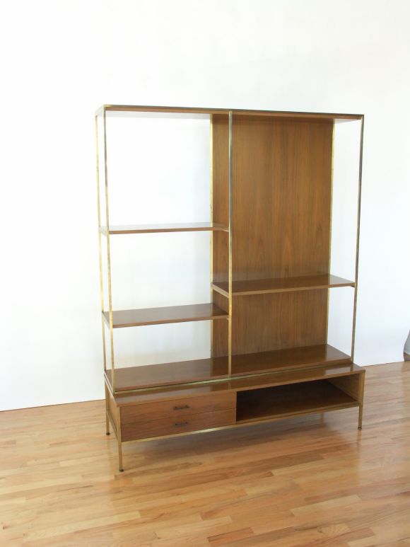 Paul McCobb designed this brass and mahogany shelf unit that was sold through Directional.  It is a versatile piece with space for displaying artwork or decorative objects, holding books and storing miscellanious items.