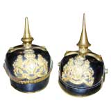 Two German 19th Century Helmets On Bronze Stands.