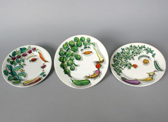 A wonderful whimsical older  set of 10 decorative plates by Fornasetti. Each displaying faces made up of an array of garden vegetables and herbs.
