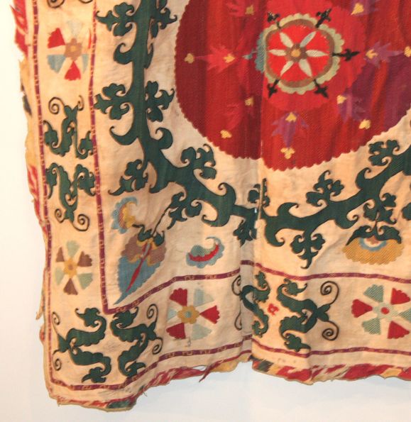 This is an early Suzani with an exagerated floral motif. These intricately embroidered tapestries were used as parts of dowries and fit well into both modernist and traditional environments.