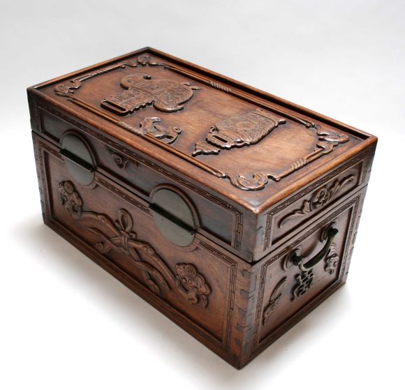 This is a nicely carved wooden chest.