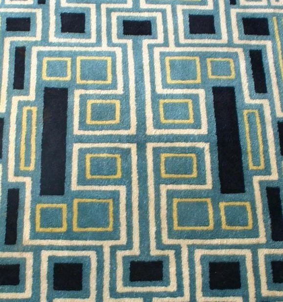 This is a fabulous hand woven carpet with a lush pile. Teal is the main color with black, white and yellow accents.