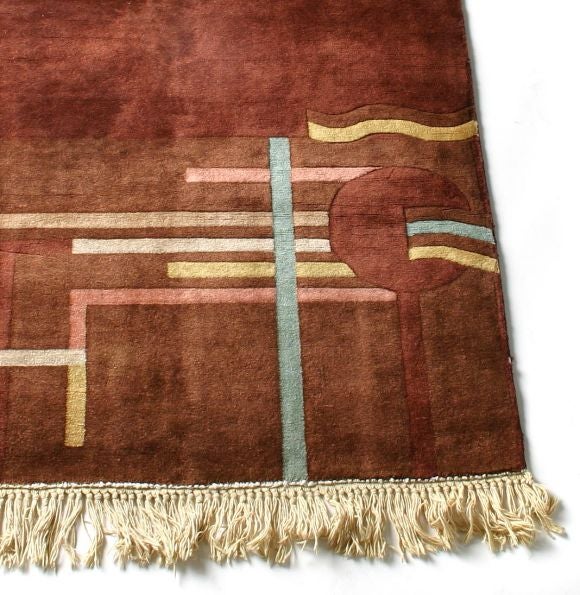 This is a wonderful hand woven carpet. the wool is thick and lusturous. There is a subtle design element of brown on brown for the background with a deco design in the foreground.