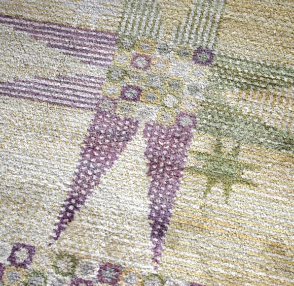 This is a wonderful modernist carpet with a pleasing, soft color palet of pale yellow, ivory, lavendar and green. The almost square size is unusual and the carpet has an interesting border.